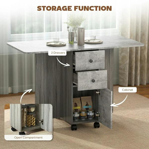 Grey drop-leaf dining table with open compartment and cabinet storage, two drawers, and wheels