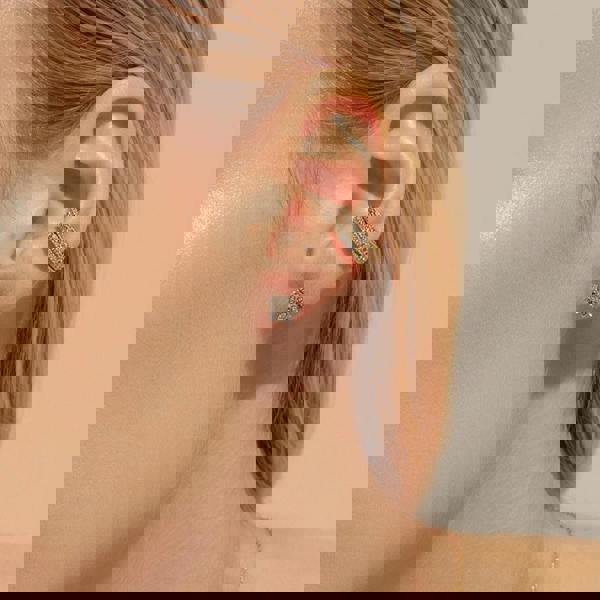 Eternal Bloom™ 14K Diamond Lotus Flower Earrings image 1. BLOOMTINE Eternal Bloom™ 14K Solid Gold Lotus Earrings featuring 12 VS1 clarity natural diamonds. These 3D layered flower studs are handcrafted in London as a symbol of spiritual awakening, offering a lifelong investment in luxury and extraordinary brilliance