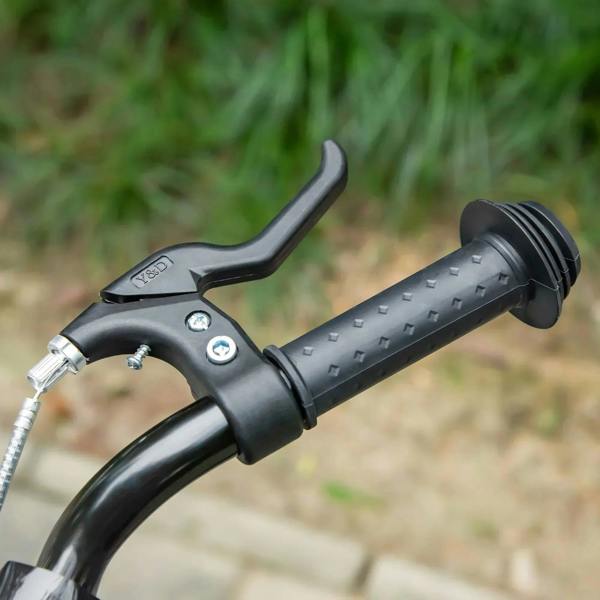 Black handlebar grips and brake lever on orange kids kick scooter