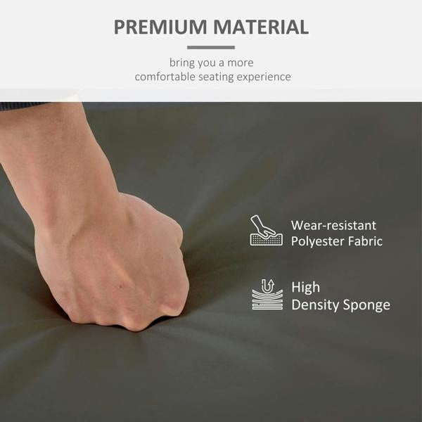 Dark gray cushion cover fabric close-up with hand pressing the padded surface