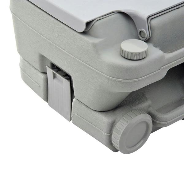 Grey portable toilet close-up of front panel, knob, and outlet valve
