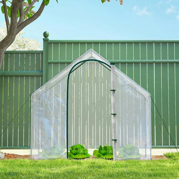 Clear PVC mini greenhouse with steel frame on grass, facing front door and roof peak