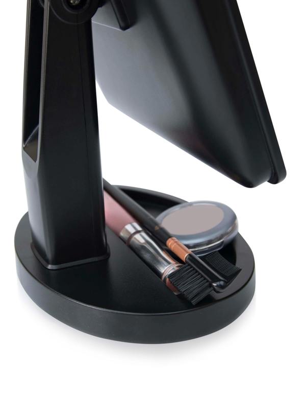 close up of base of mirror with built in cosmetic storage tray with make up stored inside 