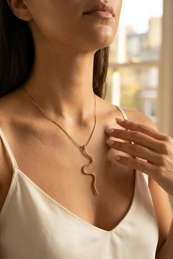 ARIIRA India Gold Tone Wavy Serpent Pendant