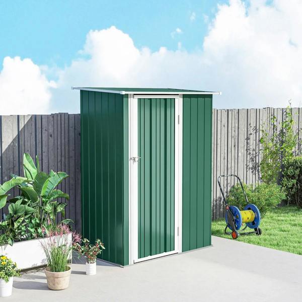 Green metal storage shed with white door panels and sloped roof