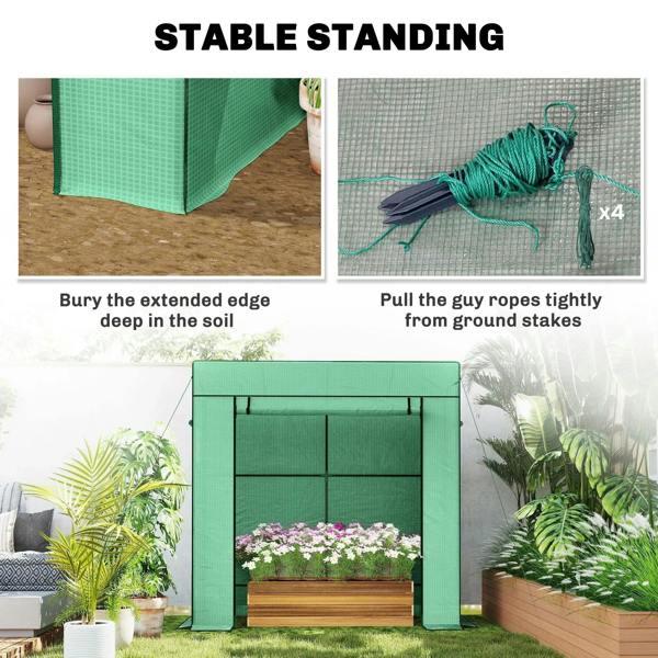 Green walk-in greenhouse with guy ropes and ground stakes for stability