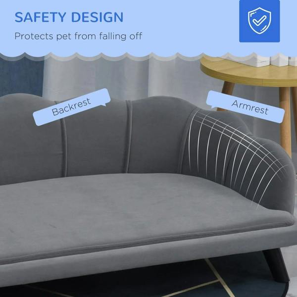 Grey dog sofa with curved backrest and armrests, padded cushioning detail