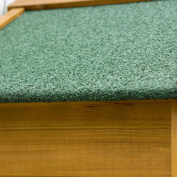 Close-up of green asphalt roof texture on a natural wood shed cabinet