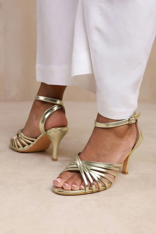 Where's That From Cyprus Wide Fit Multi Cross Over Strap Mid Heels in Gold Faux Leather