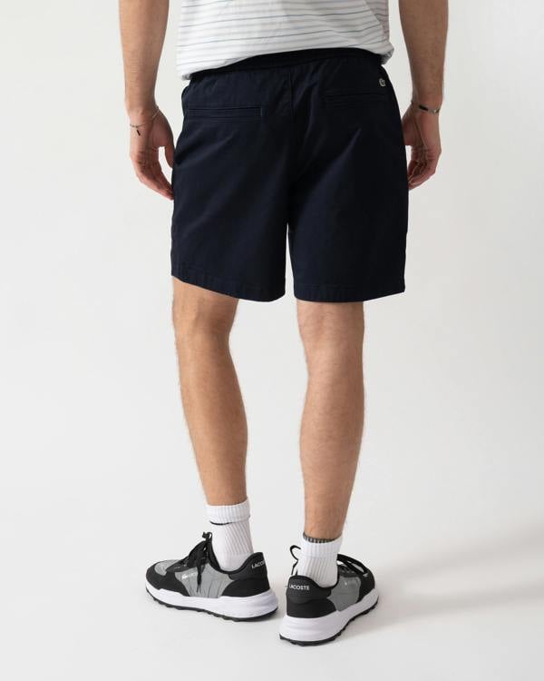 back shot of a model wearing Lacoste Relaxed Fit Mens Stretch Cotton Shorts in Abysm HDE