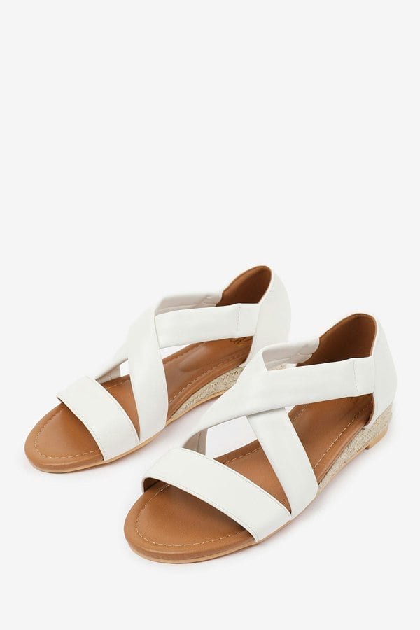 Where's That From Hummingbird Wide Fit Low Wedge Shoes With Cross Over Strap in White