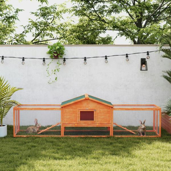 Orange wooden rabbit hutch with run and ramp, wire mesh sides, outdoor setting