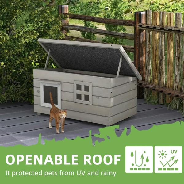 Grey wooden cat house with openable roof, two front windows, and asphalt roof