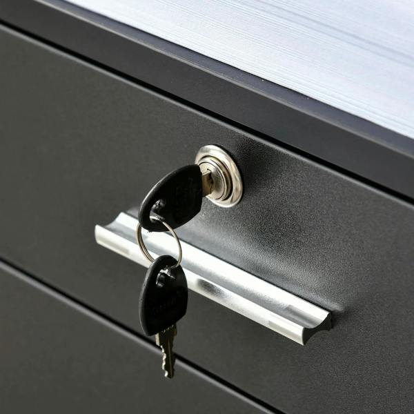 Black drawer lock with keys and metal handle on a two-drawer filing cabinet