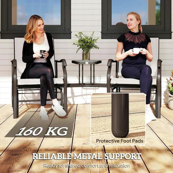 Two beige-cushioned gliding chairs with dark frames and small glass-top table