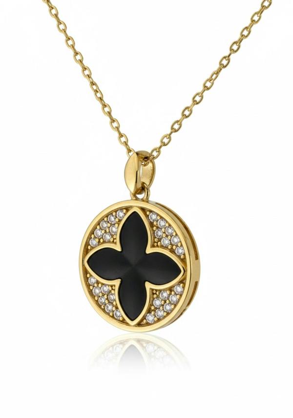 Gold necklace with a black floral pendant on a white background