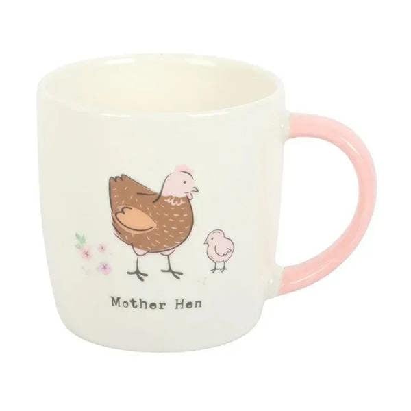White mug with pink handle and mother hen artwork with “Mother Hen” text beneath.
