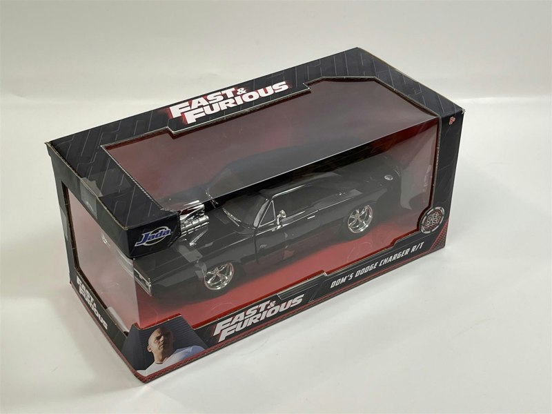 a black toy car in a box