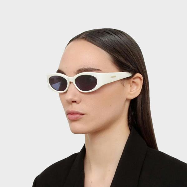 Supplied Fashion Jacquemus x Linda Farrow Ovalo oval sunglasses in white worn by a model in a black blazer