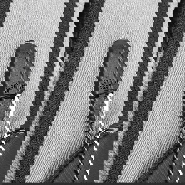 Black car charger adapter plugged into a vehicle's cigarette lighter socket with a white cable. best travel laptop backpack multi-functional