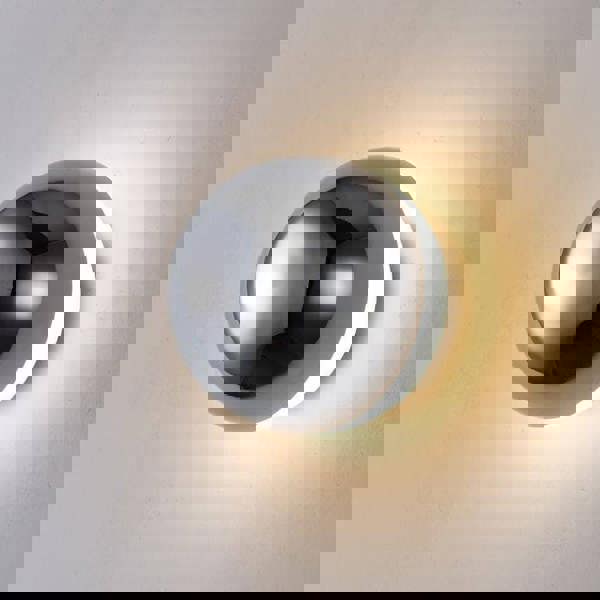 Chrome indoor wall light on a white background