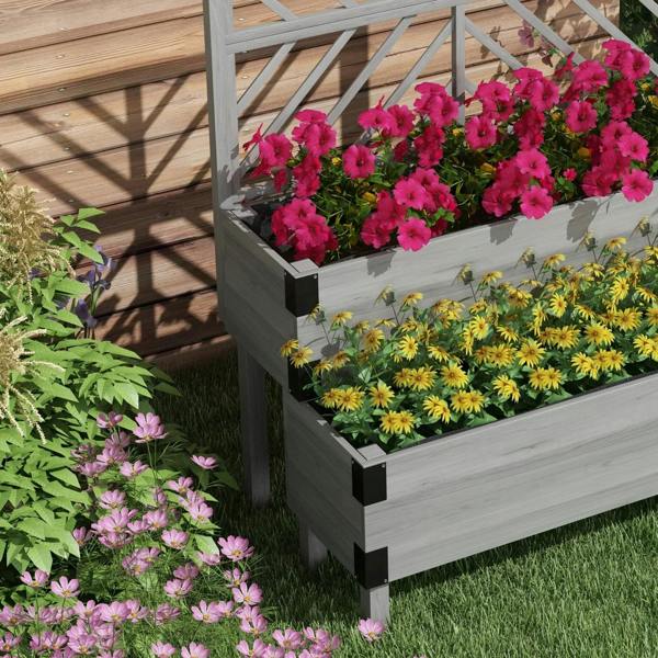 Grey 2-tier raised garden bed with trellis, filled planters with colorful flowers