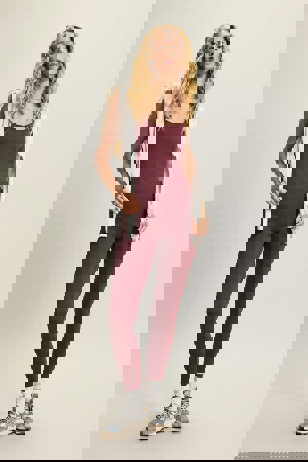 Red burgundy one-piece with adjustable straps, low cross-back design, removable pad and sculpting fit, crafted from recycled polyamide for a secure and flexible fit. Perfect for gym workouts, Pilates, or layering for casual wear.