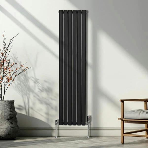 Sleek black oval column radiator with vertical bars, mounted on the wall, complemented by stylish valves and modern decor elements