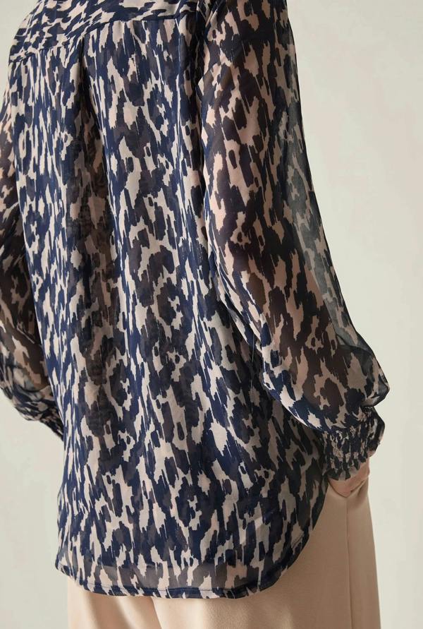 Navy abstract print blouse on mannequin angled view showing silhouette
