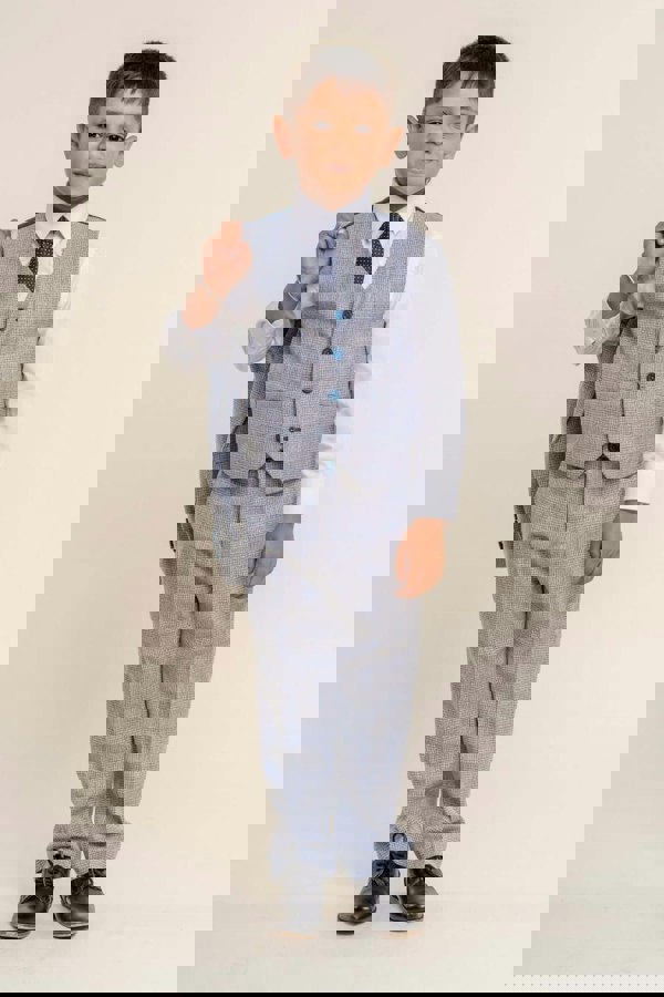 Older child wearing boys suit with jacket over shoulder