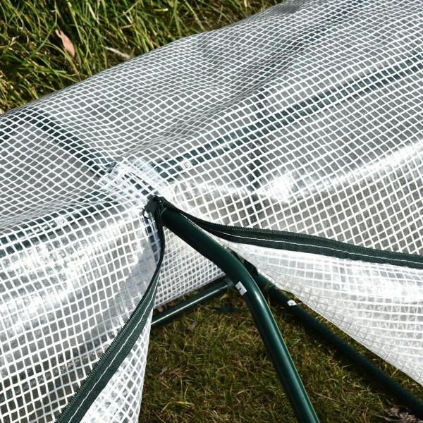 Close-up of white mesh cover secured to green greenhouse frame with straps