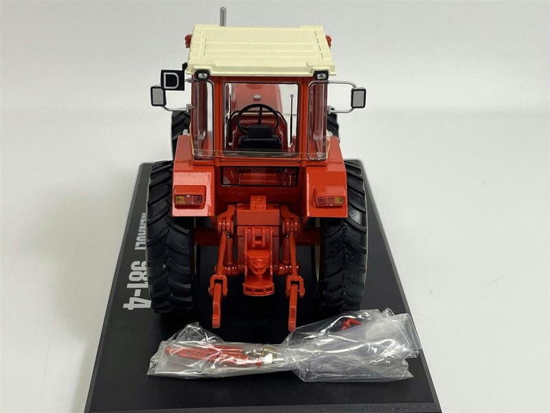 a red tractor on a black surface