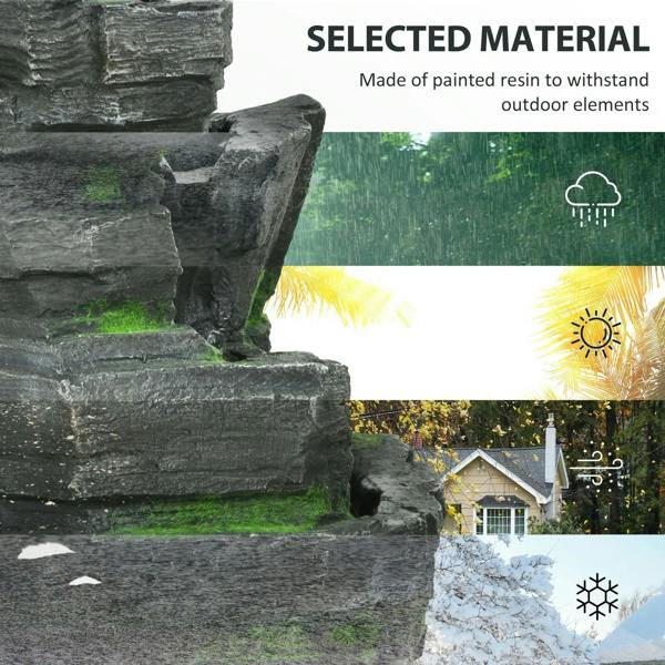 Dark grey rock fountain feature with textured surfaces and green moss