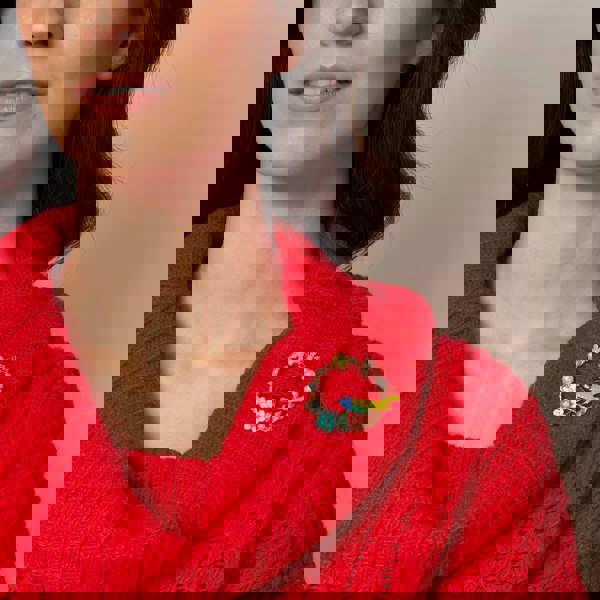 vintage brooch with bird in enamel worn on red jumper