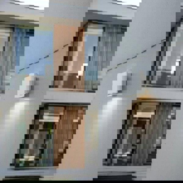 white outside wall downlight mounted on the wall outside a modern home 