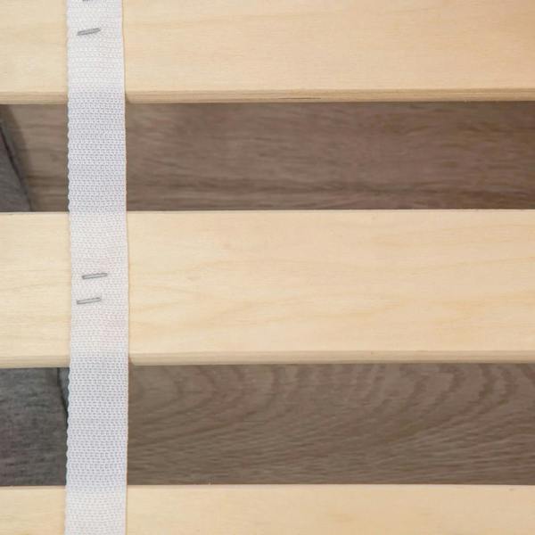 Close-up of wooden slat panels on a grey toddler bed frame