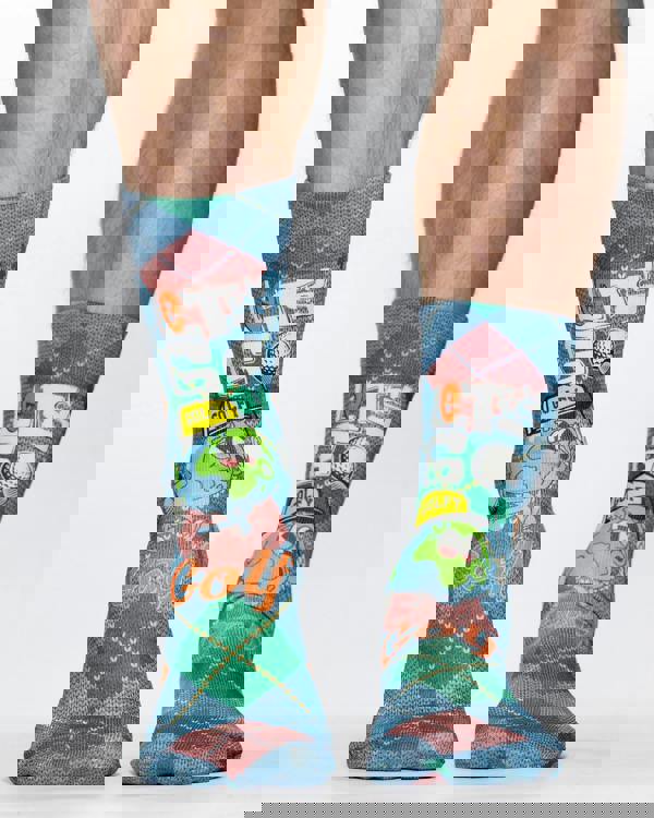 Colorful socks with golf-themed design worn by a person on a white background