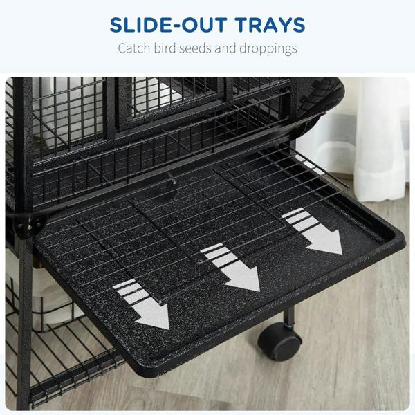 Slide-out tray on dark bird cage for catching dropped seeds