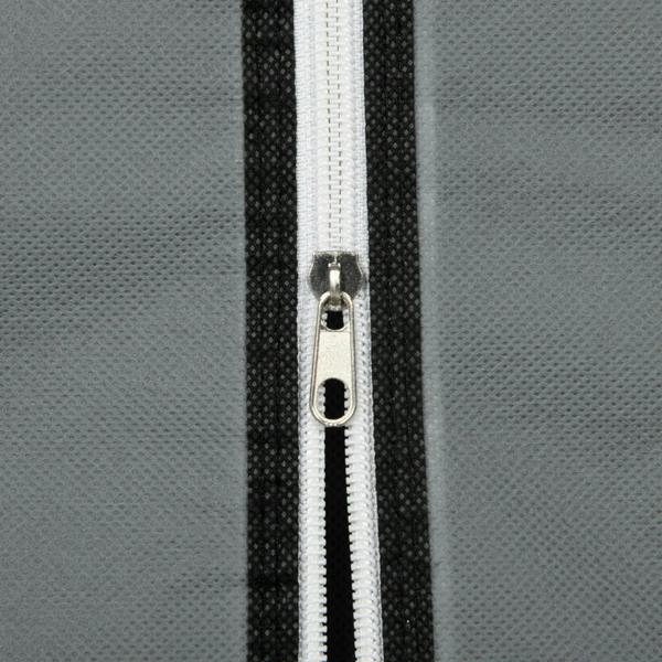 Dark grey fabric wardrobe zipper with white trim and metal pull on door edge