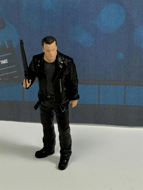 a toy figure of a man holding a gun