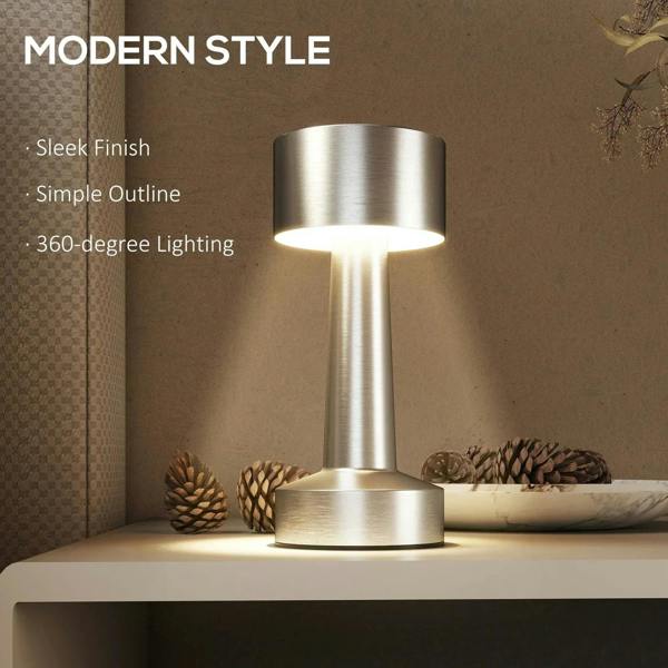 Silver cordless table lamp on shelf with warm light through cylindrical shade