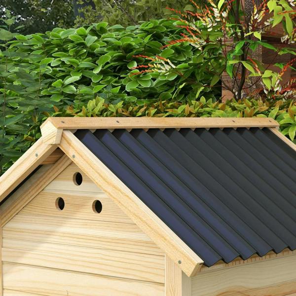 Close-up of natural wood duck house roof with ventilation holes