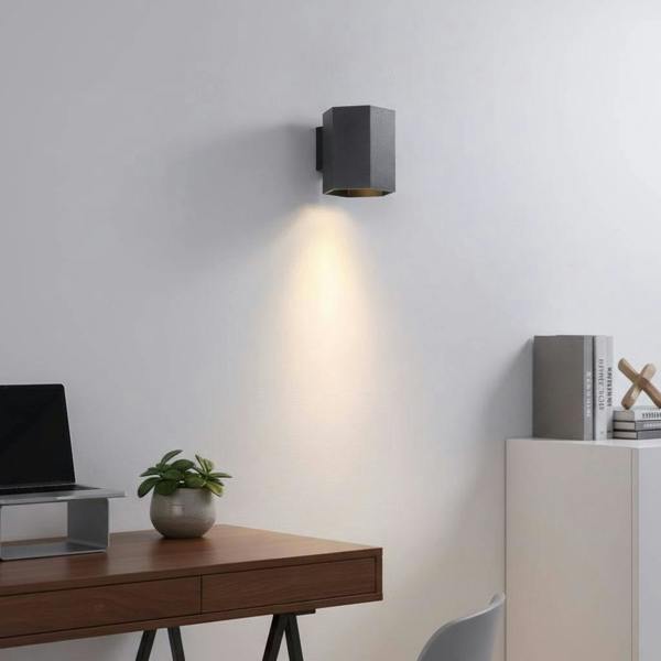 Black interior LED wall downlight on a white wall in a modern home