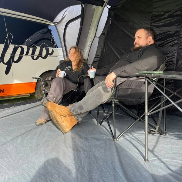 Adults using the Olympus XL Camping Chair Black & Green from OLPRO.