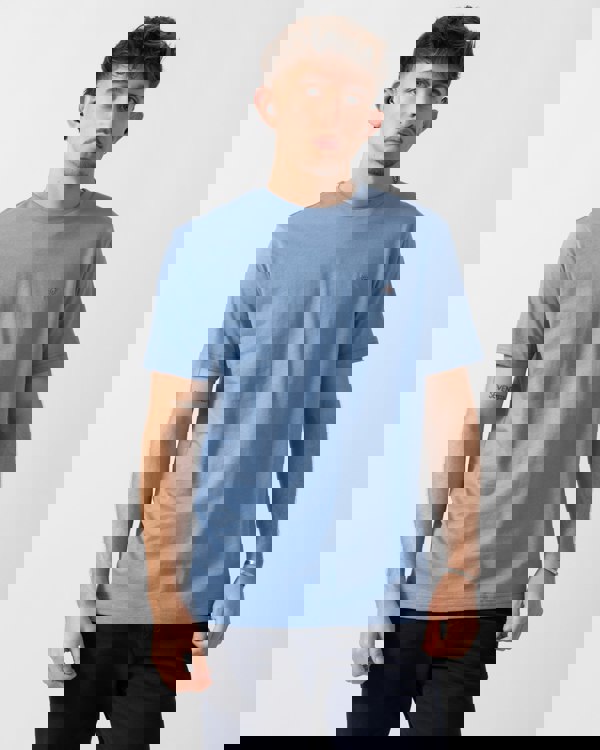 Model wearing a GANT Mens Regular Fit Short Sleeve Shield Logo T-Shirt in Faded Denim