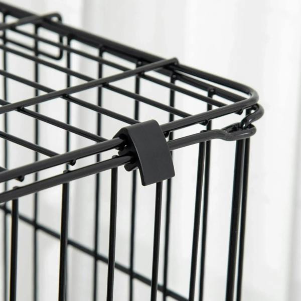 Black latch clip on a small animal cage door with metal wire bars