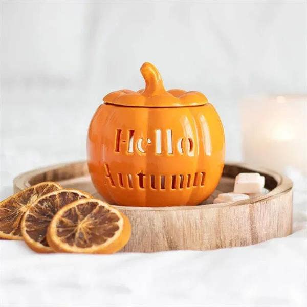 Orange pumpkin oil burner in wooden tray with lid and cutout lettering