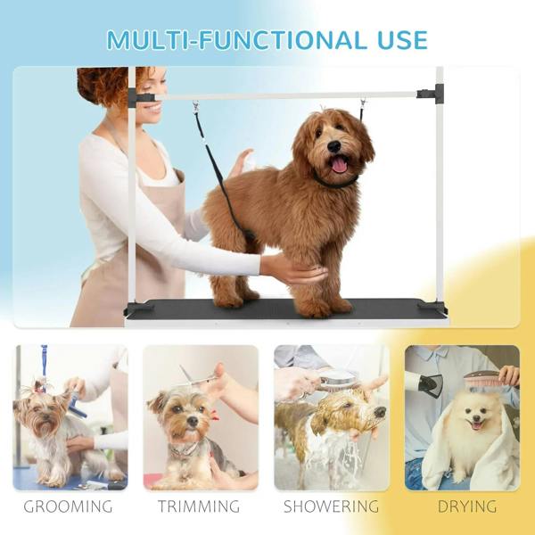 Pet grooming stand with black rubber top and hanging loops; dog on table with handler