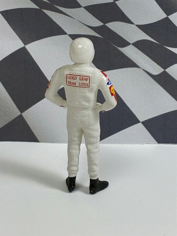 a toy figure of a man in a white uniform