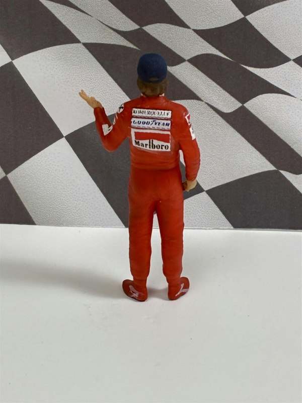 a toy figure of a man in a race suit
